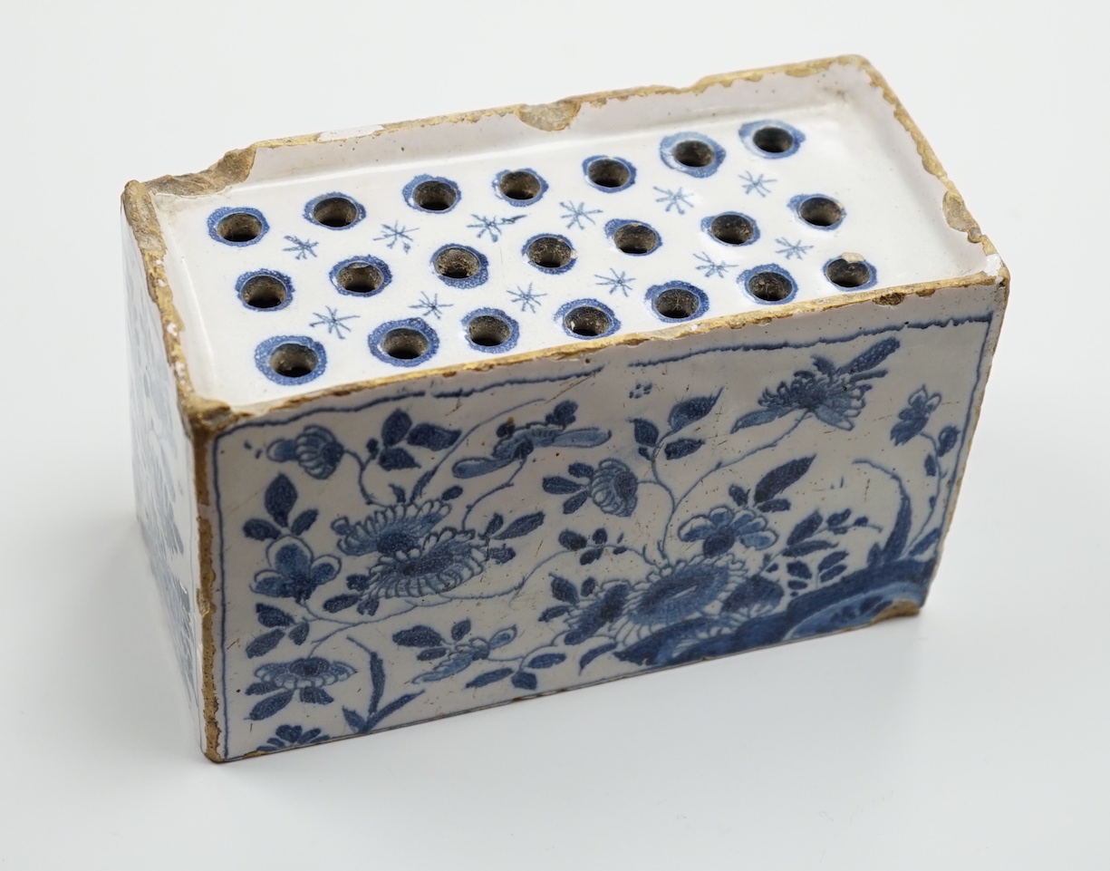 A mid 18th century English delftware flower brick, probably Lambeth, painted in underglaze blue with stylised chrysanthemums, 15cm wide